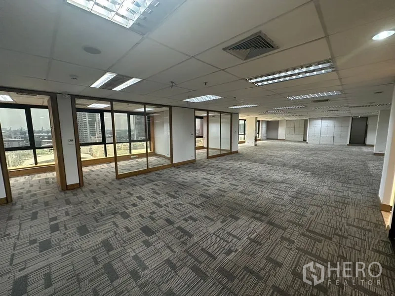 Office Space for rent in Khlong Toei, Bangkok - Open-plan office with glass-partitioned rooms and panoramic windows.