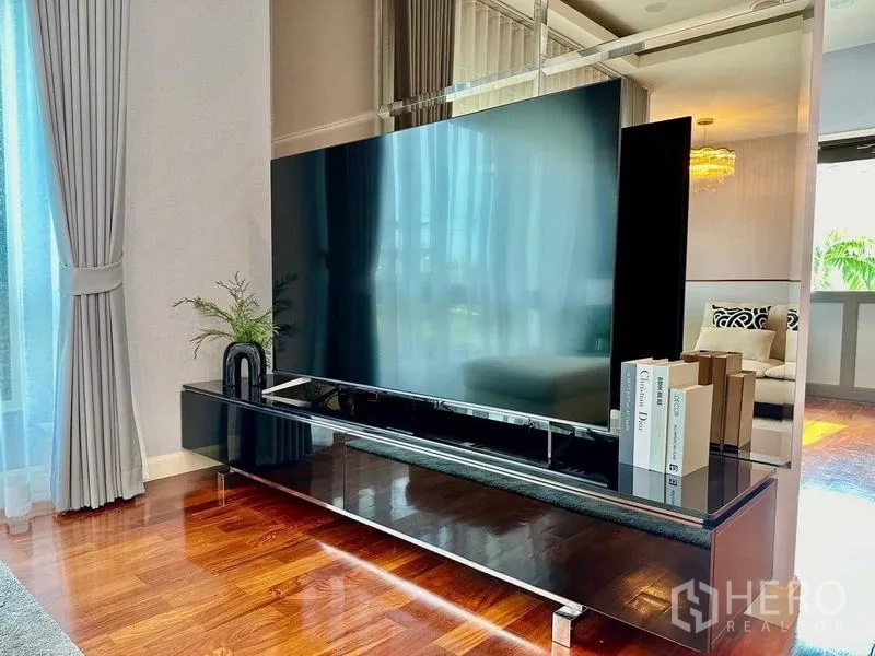 Detached House for rent in Bang Phli, Samut Prakan - Large flat-screen TV on glossy cabinet in a sunlit room.