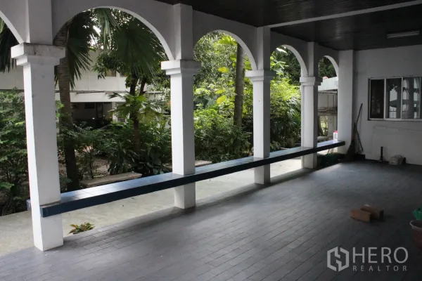 Home Office for rent in Khlong Toei, Bangkok - Shaded arcade terrace with arches overlooking a lush tropical garden.