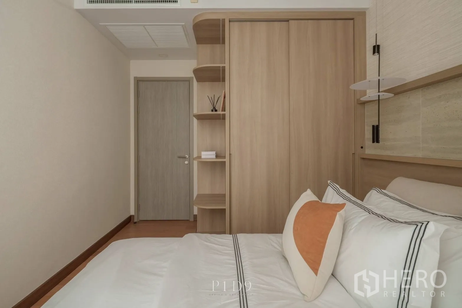 Condominium for rent in Watthana, Bangkok - Bedroom view showing built-in wardrobe and interior door.