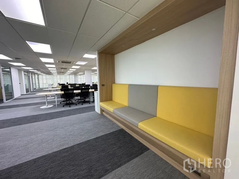 Office Space for rent - Glass-partitioned meeting rooms along corridor with carpeted flooring.