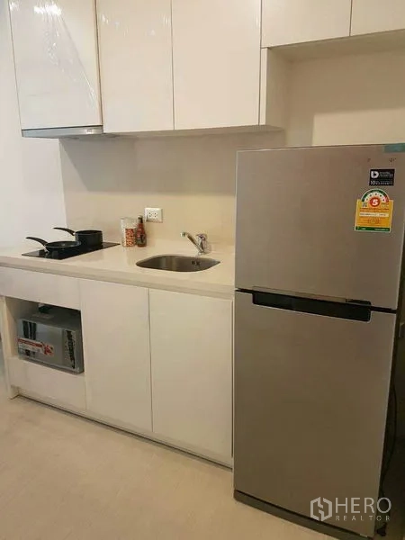 คอนโด ให้เช่าในKhlong Toei, Bangkok - ครัวบิวท์อินตู้สีขาว ซิงก์ เตาไฟฟ้า และตู้เย็นสเตนเลส