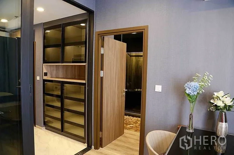 คอนโด ให้เช่าในHuai Khwang, Bangkok - พื้นที่ทางเข้าพร้อมตู้โชว์และประตูสู่ห้องนอน ตกแต่งด้วยแจกันดอกไม้