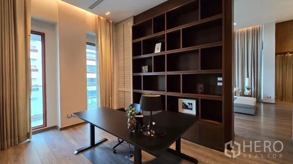 Condominium for rent - Bright home office with built-in wood shelving and large windows.