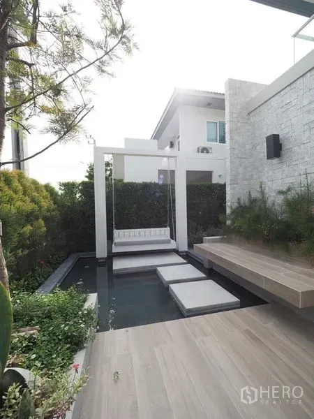 Detached House for rent in Prawet, Bangkok - Landscaped patio with water feature, stepping stones and a swing seat.