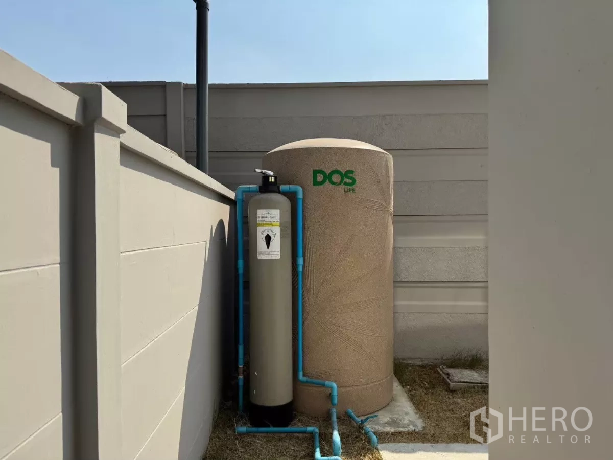 Detached House for rent in Bang Phli, Samut Prakan - Outdoor water tank and filtration system within the walled yard.