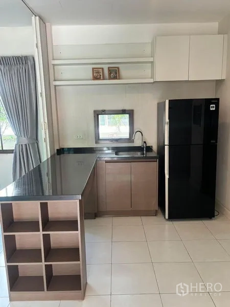 Detached House for rent in Bang Phli, Samut Prakan - Secondary pantry kitchen with long counter, sink, shelving and refrigerator.