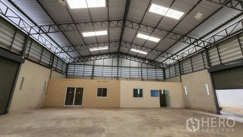 คลังสินค้า ให้เช่าในChon Buri - พื้นที่โกดังแบบโอเพ่นแปลน เห็นออฟฟิศในตัวและประตูม้วนด้านข้าง