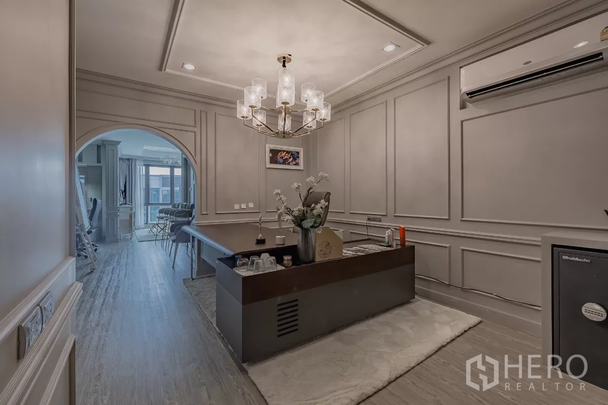 Home Office for sale in Don Mueang, Bangkok - Executive reception room with chandelier, paneled walls and arched opening to meeting area.