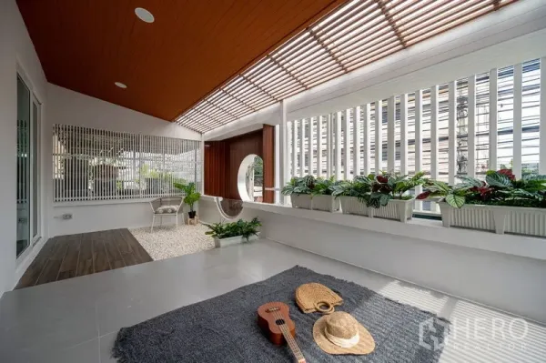 Townhouse for sale in Din Daeng, Bangkok - Large semi-outdoor terrace with slatted roof, planter boxes and a round feature window.