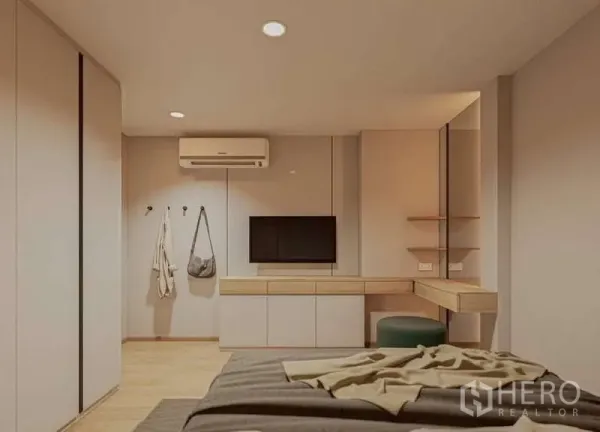 Condominium for rent in Huai Khwang, Bangkok - Bedroom view showing TV wall, vanity desk and air conditioner.