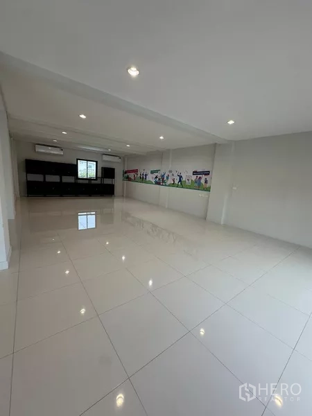 Home Office for rent - Large tiled multi-purpose room with bright lighting and a wall graphic.