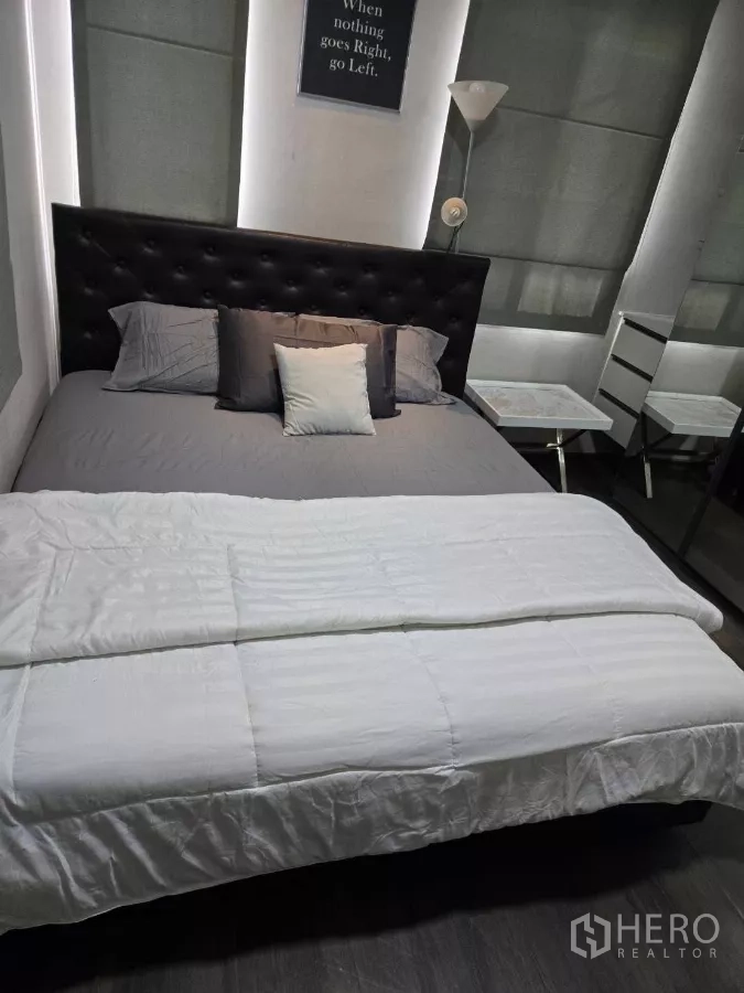 Detached House for rent or sale in Bang Phli, Samut Prakan - Guest bedroom with tufted headboard, large bed, and blackout blinds.