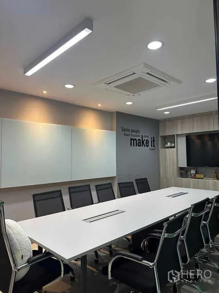 Home Office for rent in Bueng Kum, Bangkok - Conference room with whiteboard wall, TV niche, and neatly arranged meeting chairs.