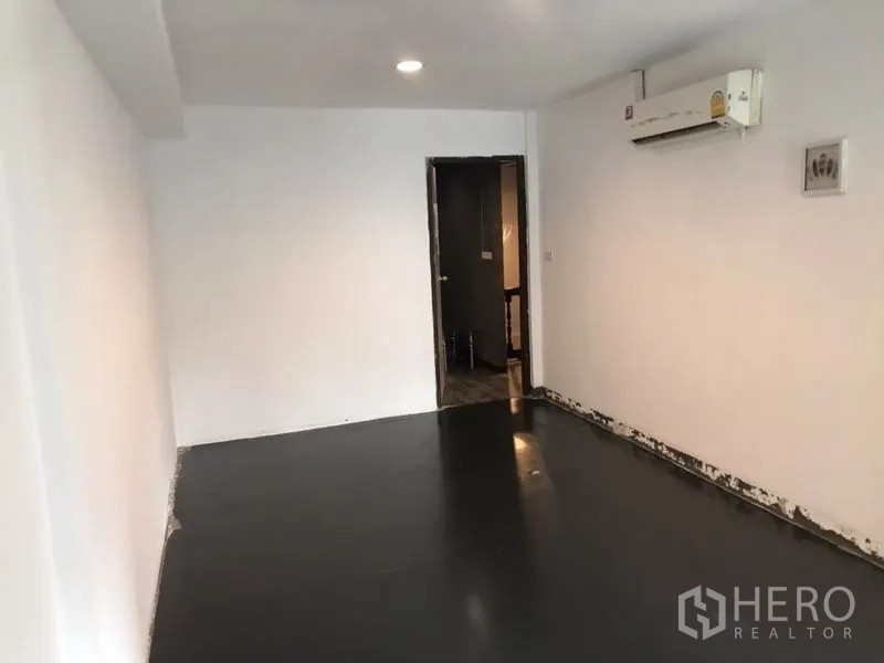 Home Office for rent or sale in Khlong Toei, Bangkok - Compact office room with wall-mounted air conditioner and doorway to the corridor.