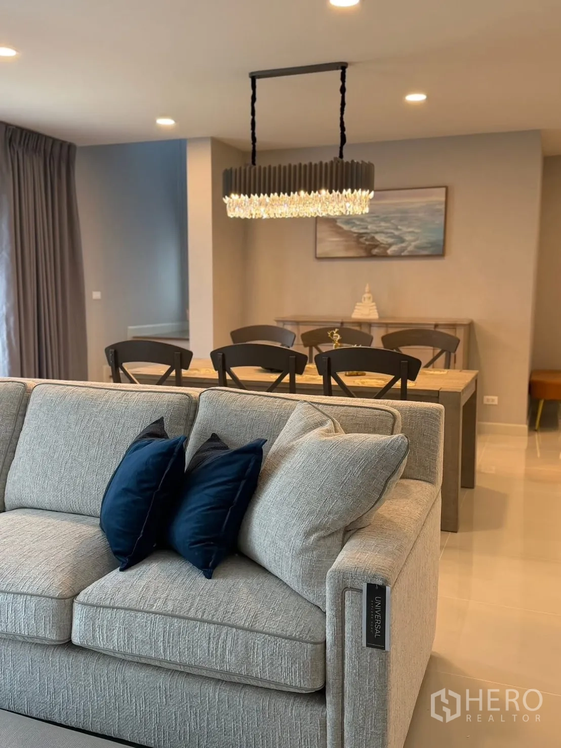 Detached House for rent in Bang Phli, Samut Prakan - Open-plan living and dining area with a light gray sofa and pendant light.
