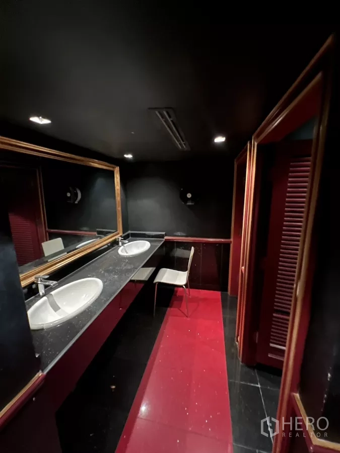 Retail Space for rent in Watthana, Bangkok - Bathroom with double sinks, long mirror and a black-and-red floor.