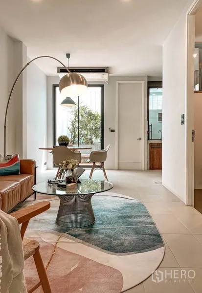 ทาวน์เฮาส์ ให้เช่าในHuai Khwang, Bangkok - พื้นที่นั่งเล่นและทานอาหารสว่างโปร่ง โซฟาหนัง โต๊ะกลางกระจก และหน้าต่างสูง