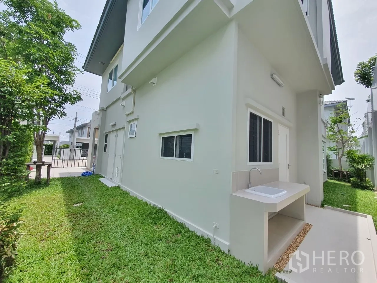 บ้าน ให้เช่าในPrawet, Bangkok - สนามหญ้าด้านข้างพร้อมอ่างล้างอเนกประสงค์และประตูบริการ.