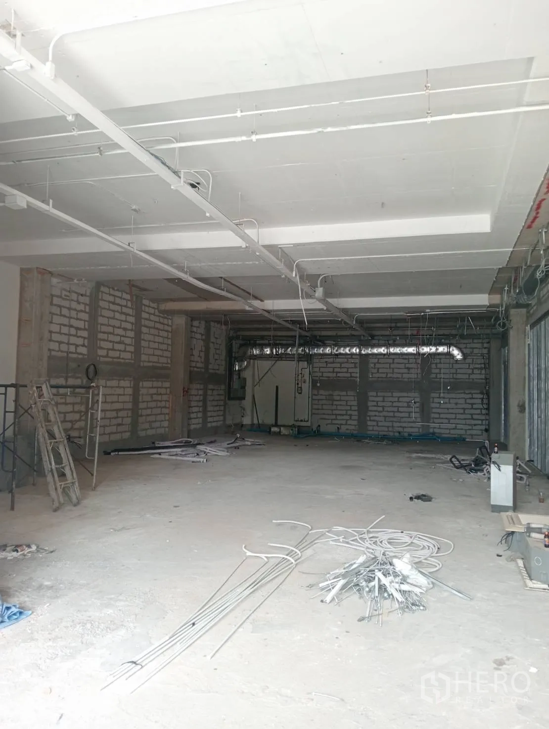 零售空间 出租 - 开放式店铺施工中，可见管线与高楼板。