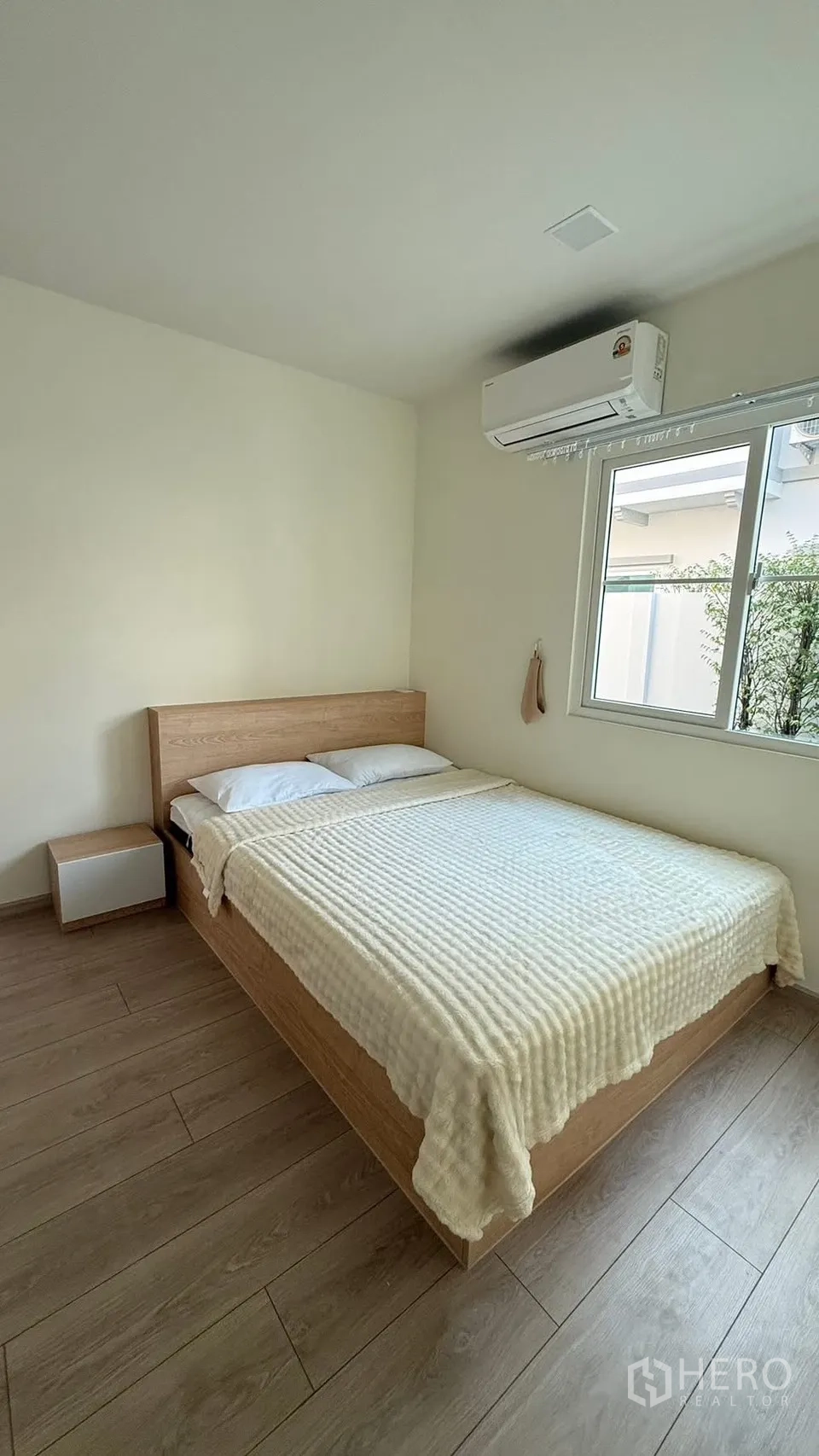 Detached House for rent in Bang Phli, Samut Prakan - Cozy bedroom with bed by the window, AC unit and garden outlook.