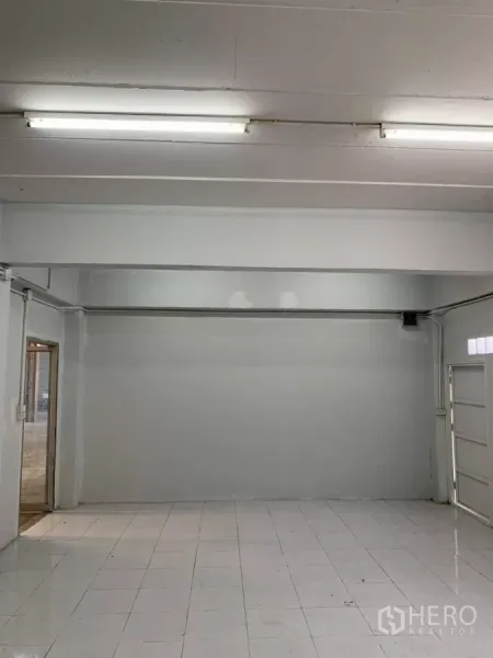 Warehouse for rent in Min Buri, Bangkok - Clean white office space with fluorescent lighting and tiled flooring.