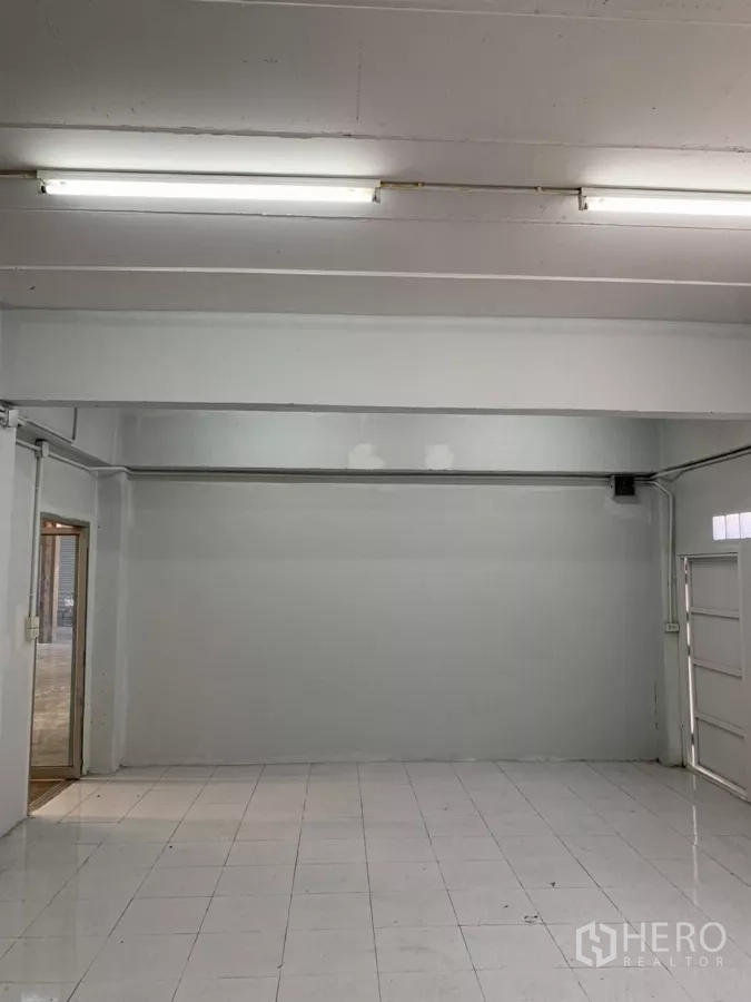 Warehouse for rent in Min Buri, Bangkok - Clean white office space with fluorescent lighting and tiled flooring.