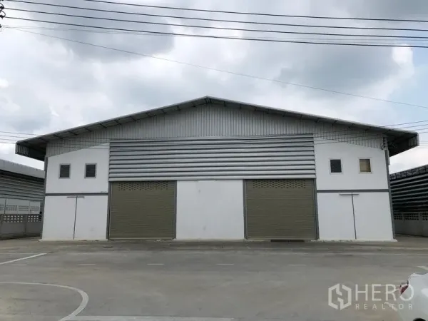 คลังสินค้า ให้เช่าในSam Khok, Pathum Thani - ด้านหน้าของโกดังสมัยใหม่ ประตูม้วน 3 บาน พร้อมลานคอนกรีตกว้าง ที่อำเภอสามโคก ปทุมธานี