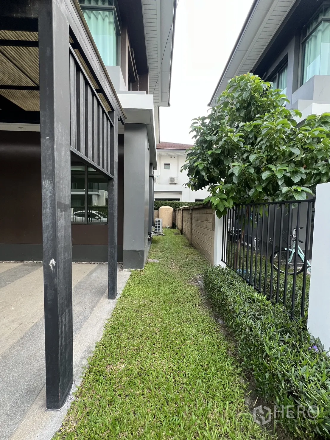 บ้าน ให้เช่าในBang Kapi, Bangkok - สวนข้างบ้านทางเดินหญ้าตามแนวรั้วและต้นไม้