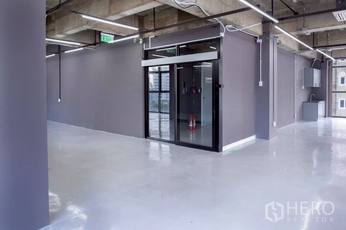 Office Space for rent - Main entry with sliding glass door, gray walls and a compact pantry.