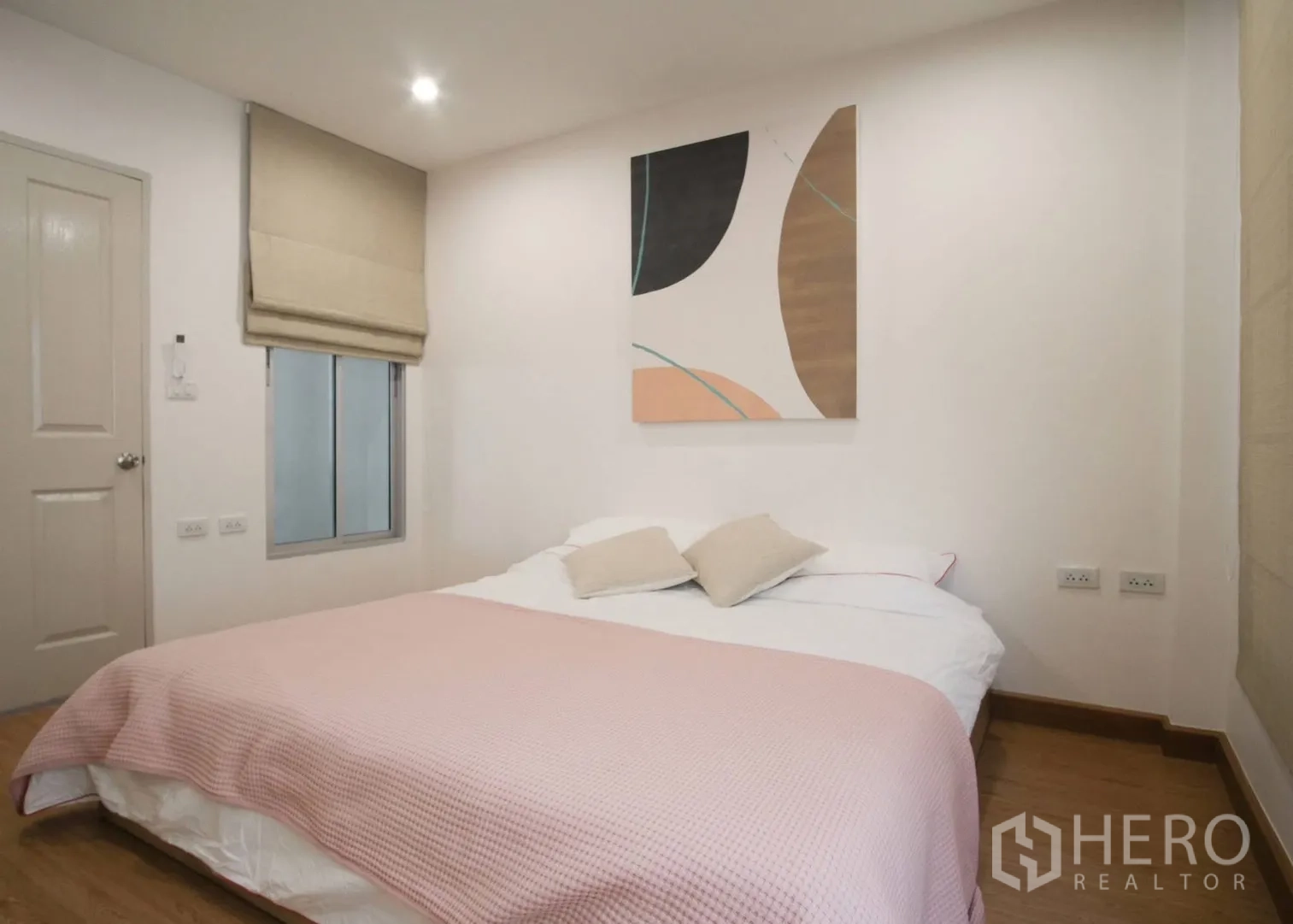 Townhouse for rent in Bang Phli, Samut Prakan - Minimal bedroom with double bed, wall artwork, and a window with blinds.