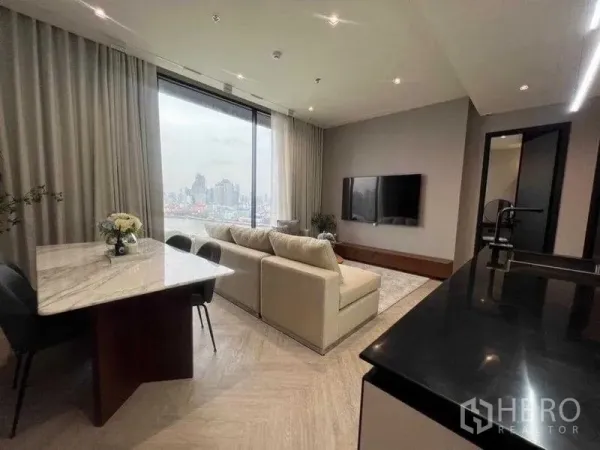 Condominium for rent in Khlong San, Bangkok - Open living, dining and kitchen zone facing a large picture window with city and river panorama.