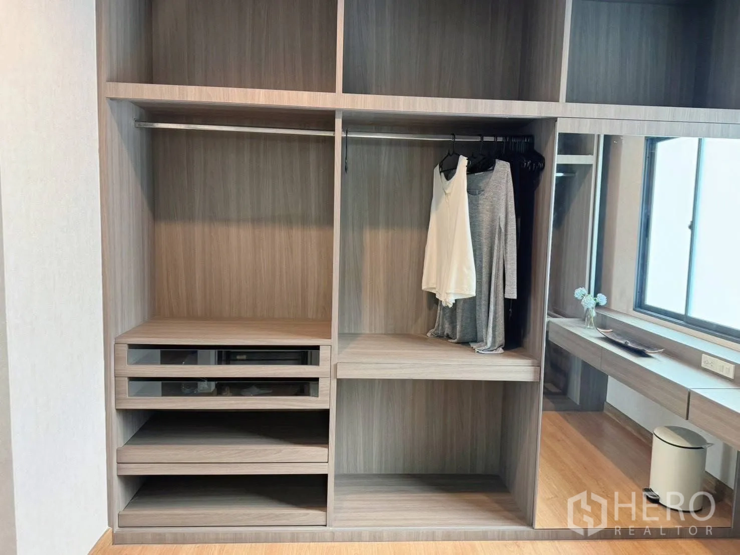 Detached House for rent or sale in Suan Luang, Bangkok - Close-up of built-in closet compartments and hanging rail.