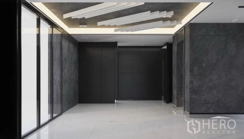 Office Space for rent in Lat Krabang, Bangkok - Lobby finished in dark stone with feature ceiling and glass walls.