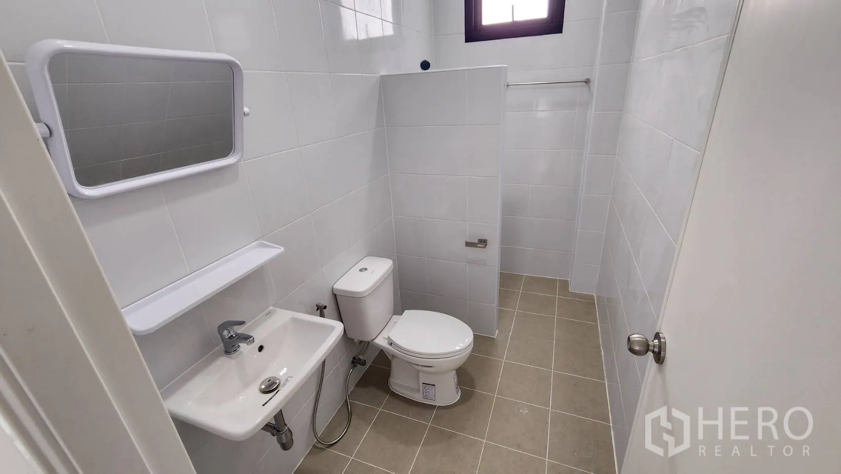 Factory for rent or sale in Bang Bo, Samut Prakan - Rear elevation of the factory with metal cladding, external ladder and large concrete yard for trucks.