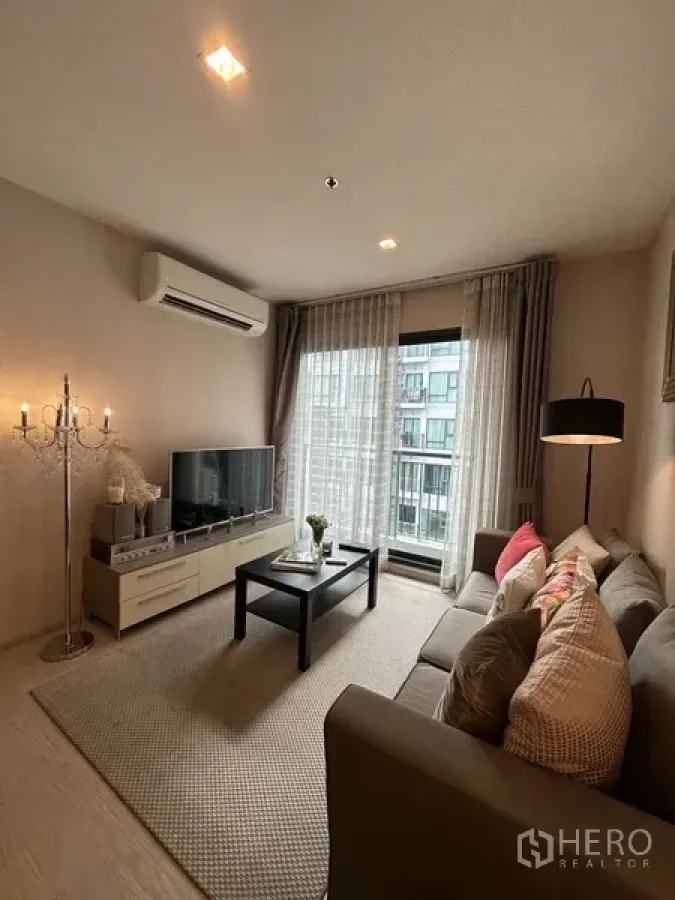 คอนโด ให้เช่าหรือขายในKhlong Toei, Bangkok - พื้นที่นั่งเล่นพร้อมทีวี เครื่องปรับอากาศ โต๊ะกลาง และประตูกระจกสู่ระเบียง