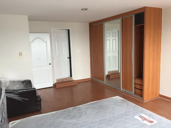 คอนโด ให้เช่าในKhlong Toei, Bangkok - มุมห้องนอนเห็นตู้เสื้อผ้าบิลท์อินบานกระจกขนาดใหญ่และประตูสีขาวสองบาน