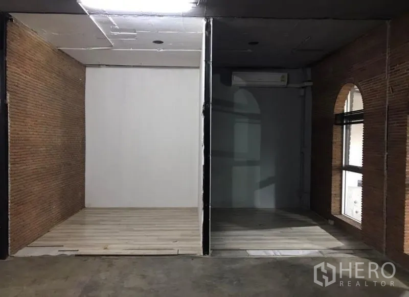 Office Space for rent in Watthana, Bangkok - Two partitioned bays with wood-look floors, brick walls and air conditioning.