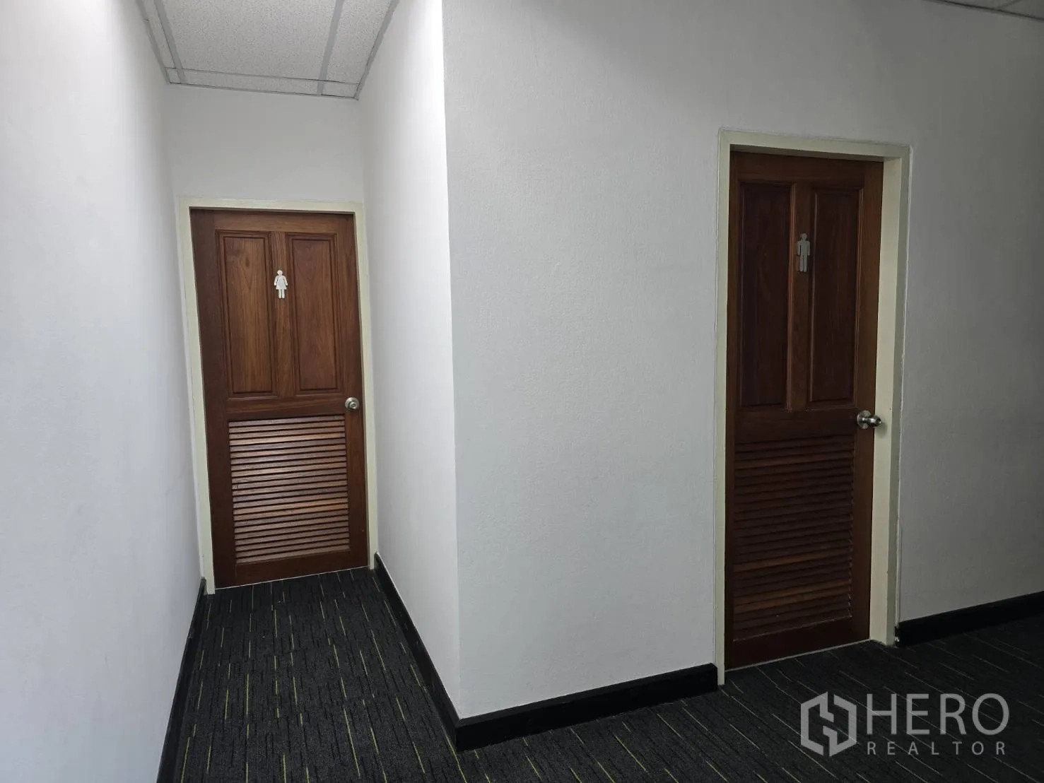 Office Space for rent in Watthana, Bangkok - Hallway with separate male and female restroom doors.