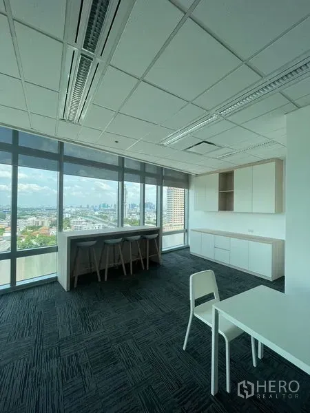 Office Space for rent in Dusit, Bangkok - Pantry and casual bar seating beside floor-to-ceiling windows overlooking the city.