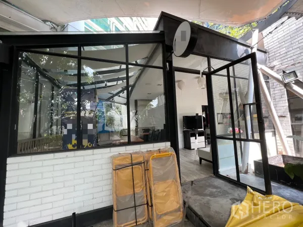 零售空间 出租在Pathum Wan, Bangkok - 转角玻璃店面，敞开的双扇玻璃门与有顶走道连接室内。