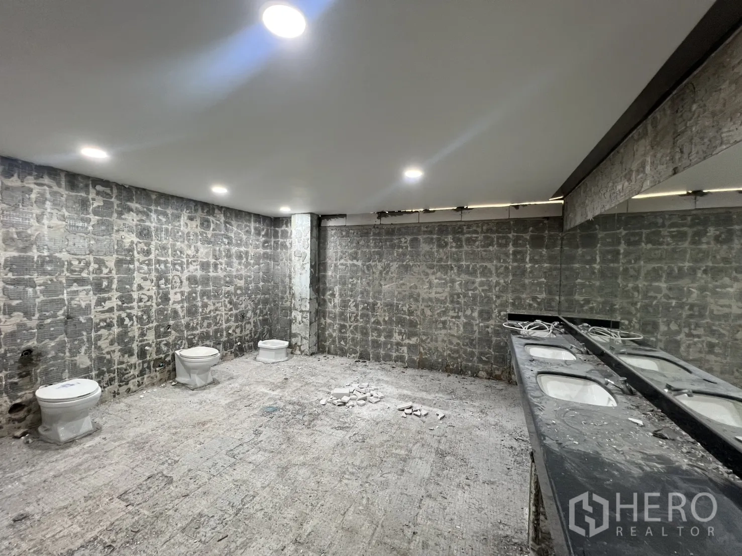 Office Space for rent in Watthana, Bangkok - Restroom area under refurbishment with fixtures and counters awaiting new finishes.