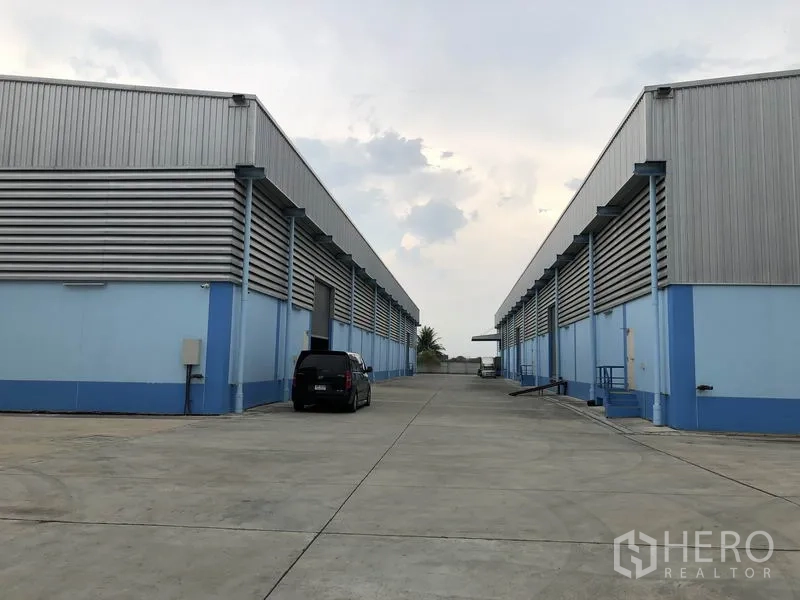 Warehouse for rent in Samut Prakan - Twin warehouse rows with concrete yard, truck access and parking for easy logistics.