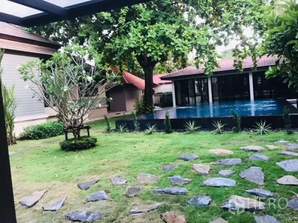 Detached House for rent in Khlong Toei, Bangkok - Landscaped garden with stepping-stone path leading to a private swimming pool and pavilion.