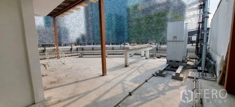 Shophouse for sale - Rooftop service area with equipment platforms and railings.