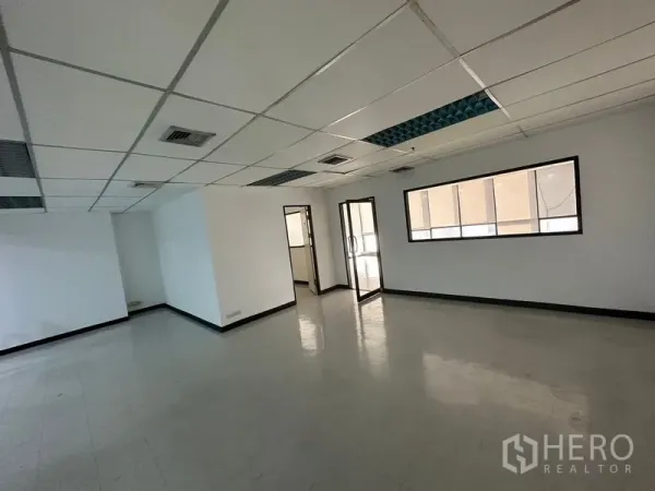 Office Space for rent in Ratchathewi, Bangkok - Open-plan office area with suspended ceiling, air vents, internal glass door and a partitioned meeting room.