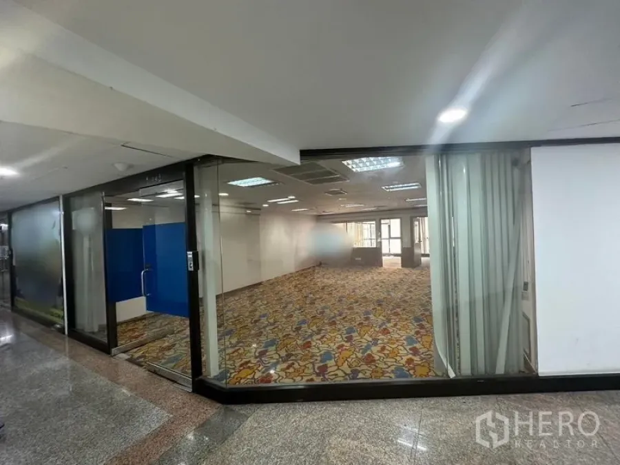 สำนักงาน ให้เช่า - ยูนิตออฟฟิศกระจกเต็มบาน แสงสว่าง เพดานไฟ และพรมลาย มองจากโถงทางเดิน