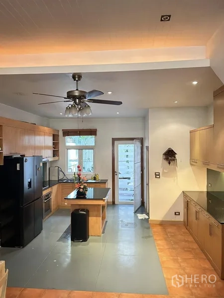 ทาวน์เฮาส์ ให้เช่าหรือขายในKhlong Toei, Bangkok - ห้องครัวขนาดครอบครัวพร้อมไอส์แลนด์ พัดลมเพดาน และประตูออกลานหลังบ้าน