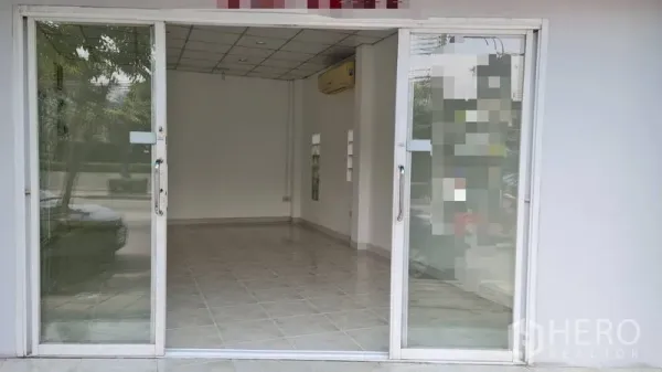 Shophouse for rent - Open glass doors revealing a bright tiled retail space