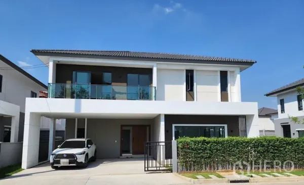 Detached House for rent in Don Mueang, Bangkok - Front exterior of the house with two-car carport, glass balcony and neat landscaping.